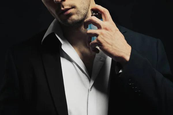 depositphotos_150302402-stock-photo-handsome-young-man-using-perfume (1)