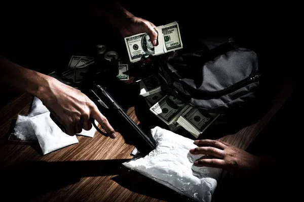 depositphotos_143734387-stock-photo-drug-dealer-use-gun-to