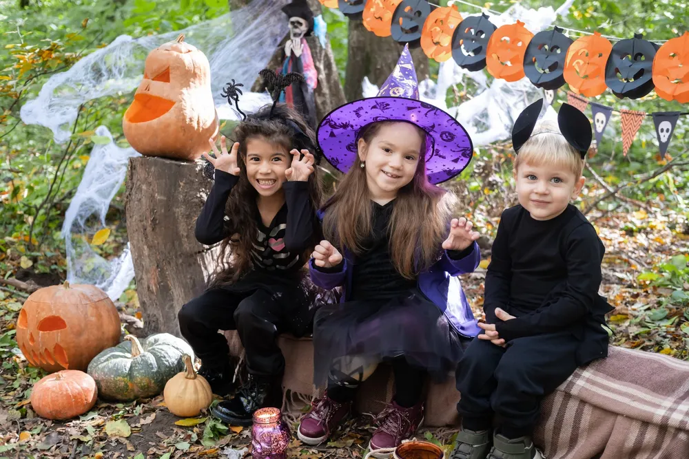 happy-kids-halloween-costumes-having-fun-halloween-decorations-outdoor-scaled